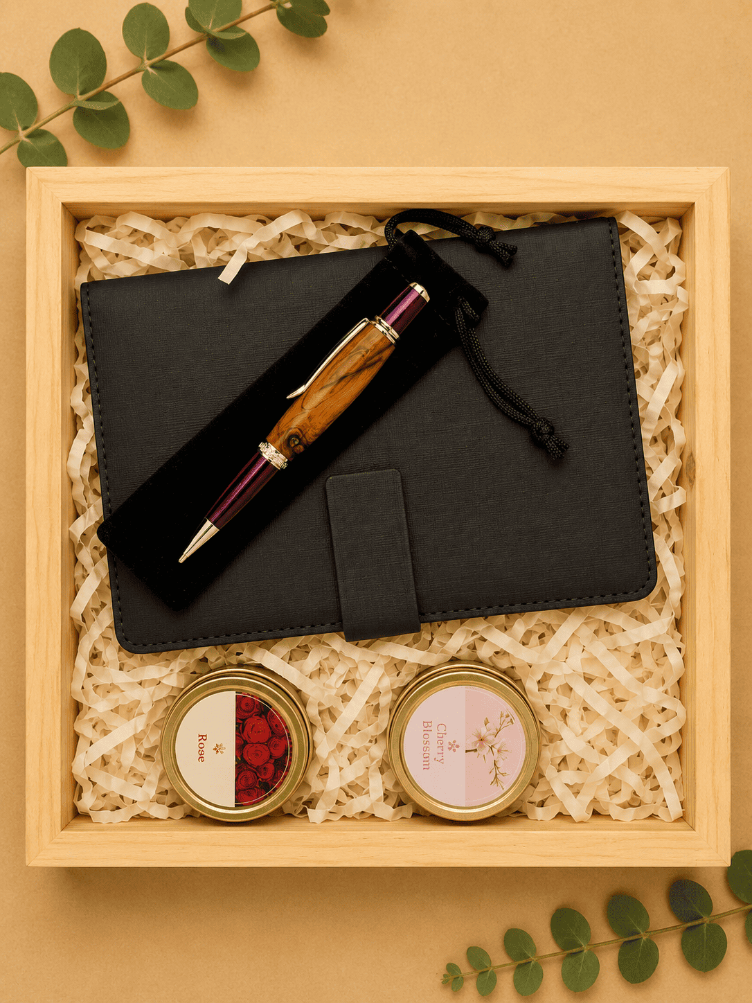 Elegant gift box with pen, notebook, and candles for luxury gifting.