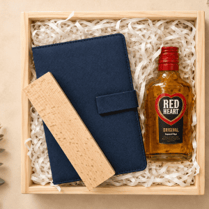 Gift box with whiskey, navy notebook, and wooden pen for The Heritage Gift Box.